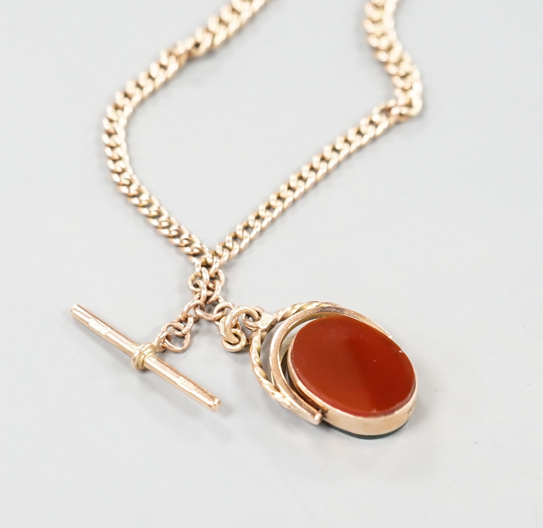 An Edwardian 9ct gold albert, with carnelian set spinning fob seal, chain 43cm, gross weight 36.5 grams.